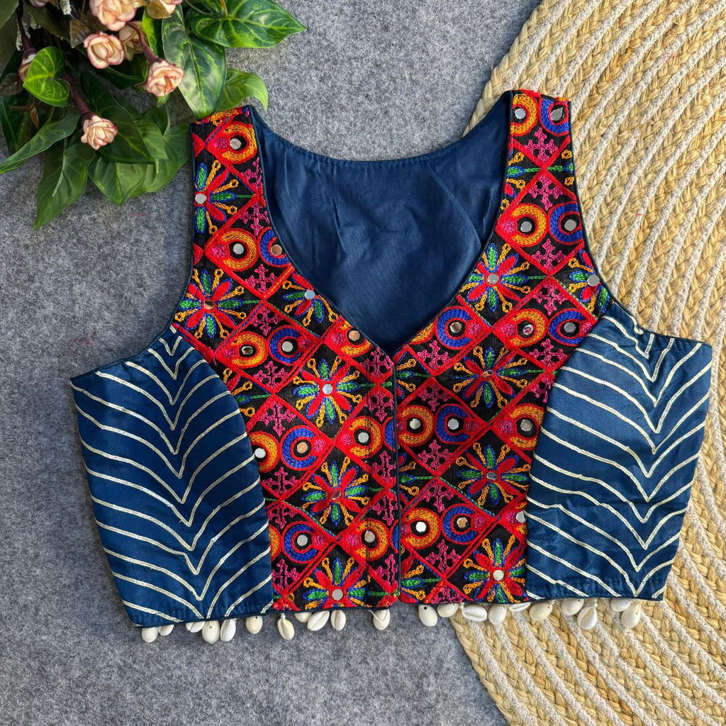 Navy blue sleeveless blouse with red, blue, green multi-color Gamthi patch embroidery, mirror work, and white shell tassels for women