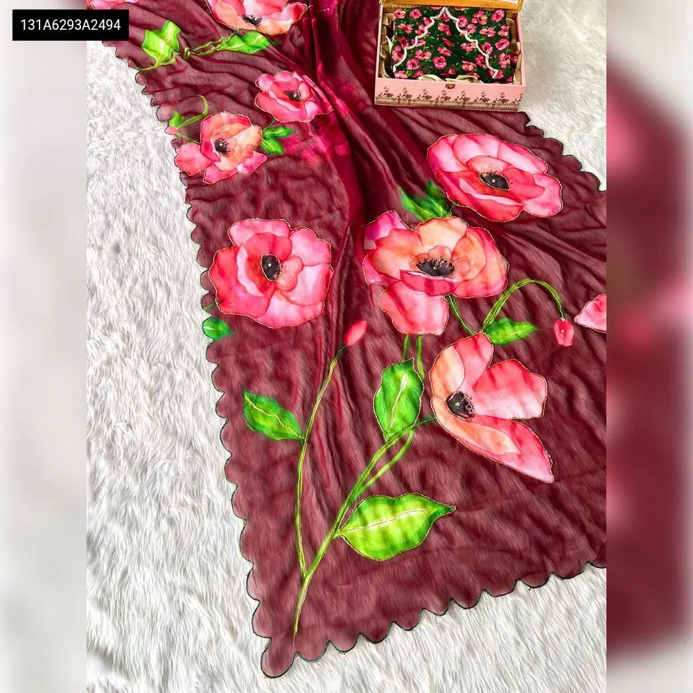 Flat lay of maroon Georgette saree with large pink poppy digital print and subtle handwork, featuring a scalloped edge.
