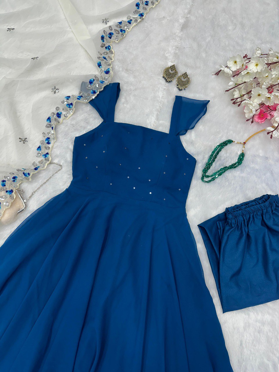 TRENDBUY Sapphire Blue Georgette Anarkali Suit with sequin detail, flat lay with embroidered dupatta and accessories.