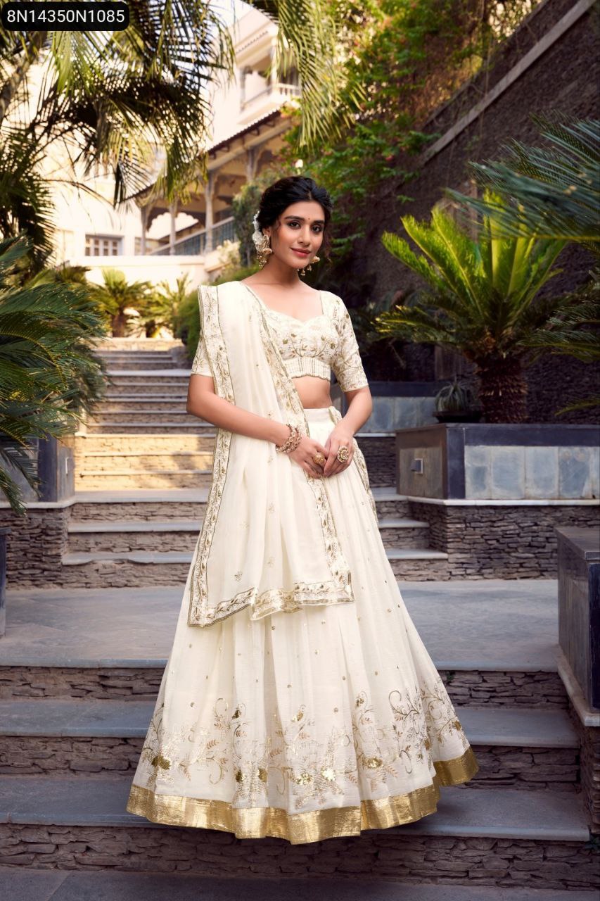 Full body view of model wearing Off-white Glam Lehenga Choli with Sequins and Embroidery, front view, standing on stairs.