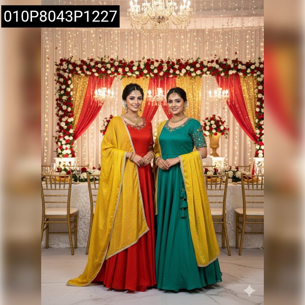 Two women model festive Maggam Work Vichitra Silk Gowns with Chinnon Silk Dupattas; one in red, one in green, at a decorated event.
