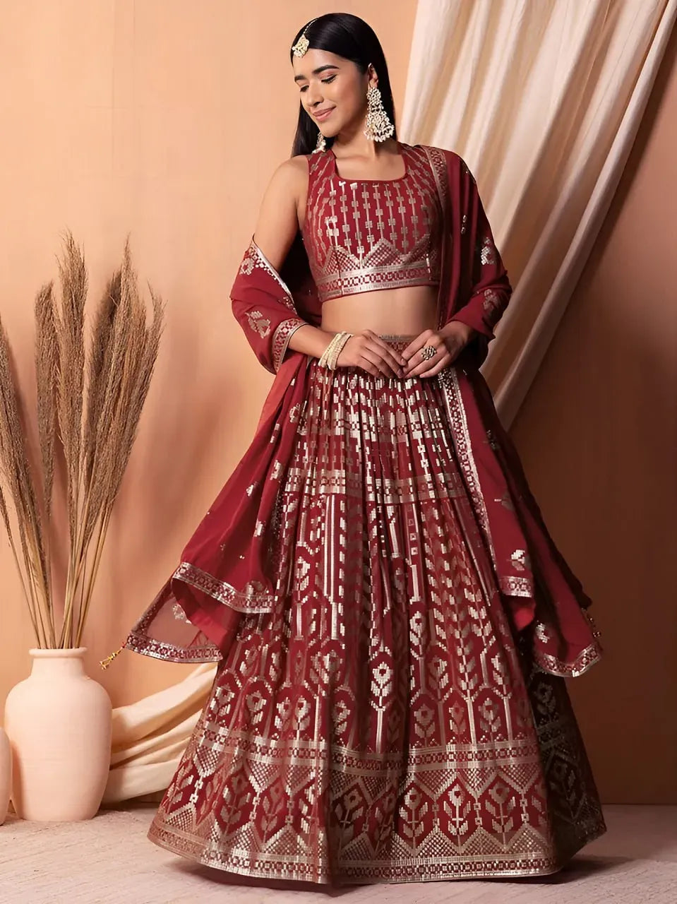 Full body shot of model wearing maroon sequin designer lehenga choli with dupatta