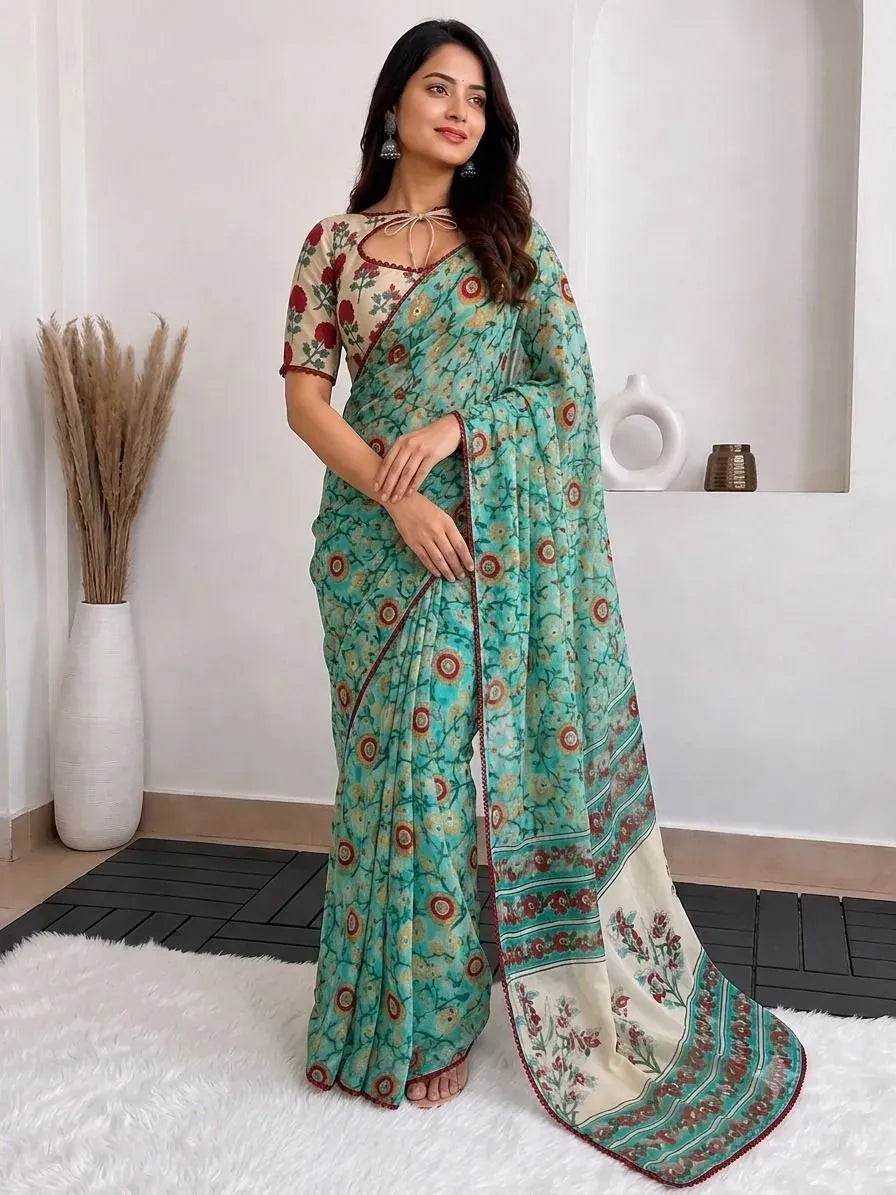 Full length standing view of model in turquoise georgette printed festive saree