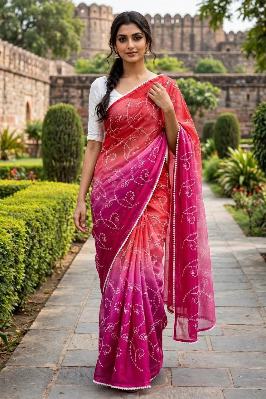 Model wearing red and pink gradient soft kota doria saree with white lace border
