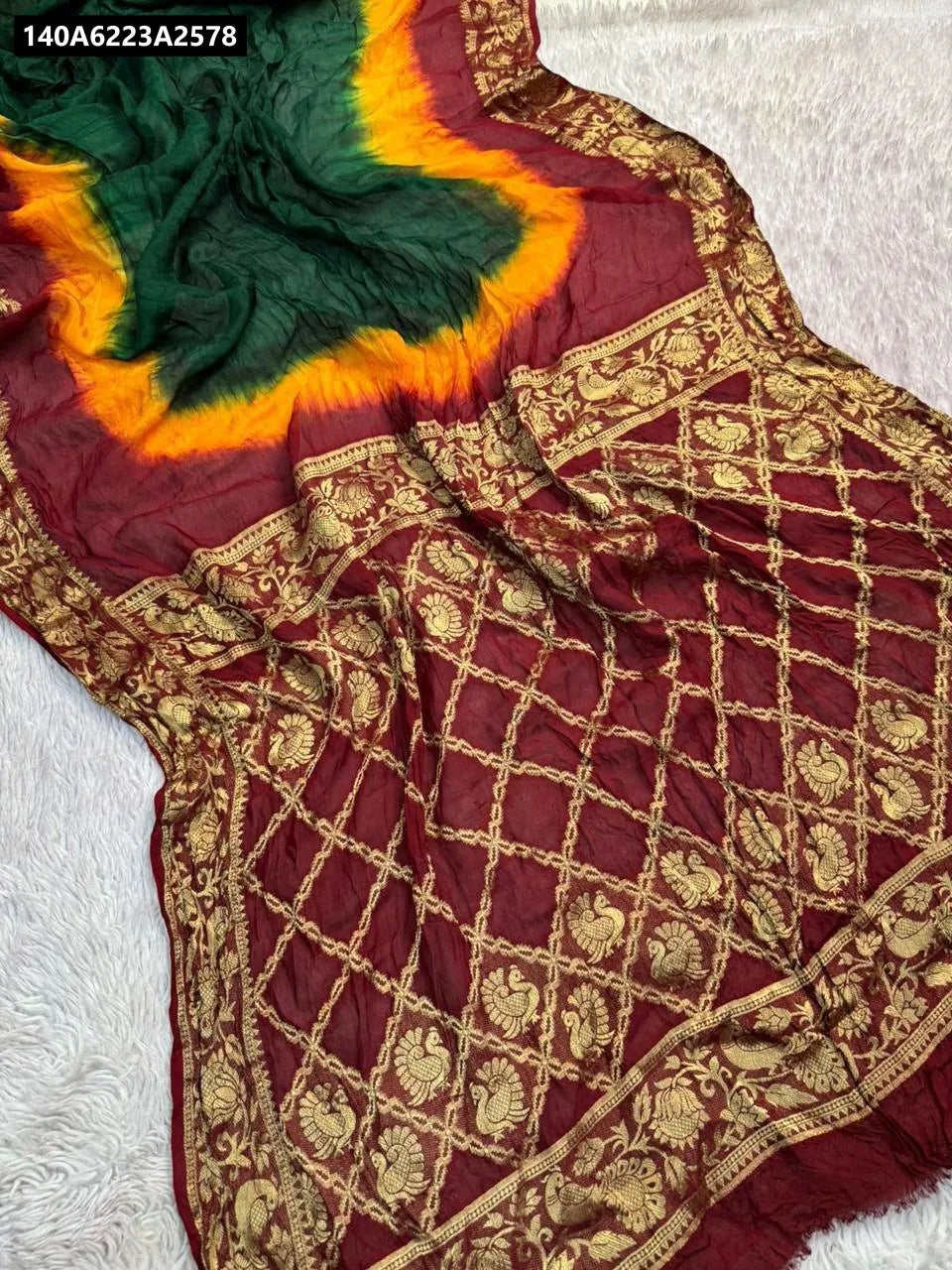 TRENDBUY Hand-Dyed Bandhani Cotton Silk Saree, multi-color with vibrant red, green, and yellow, intricate gold detailing, flat lay.