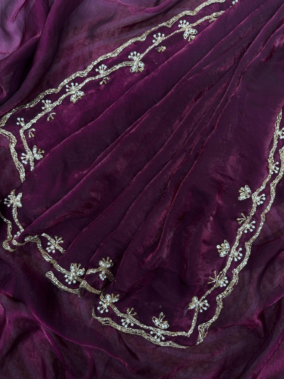 Close-up of Aubergine Handcrafted Satin Saree border with intricate gold beadwork and white embellishments