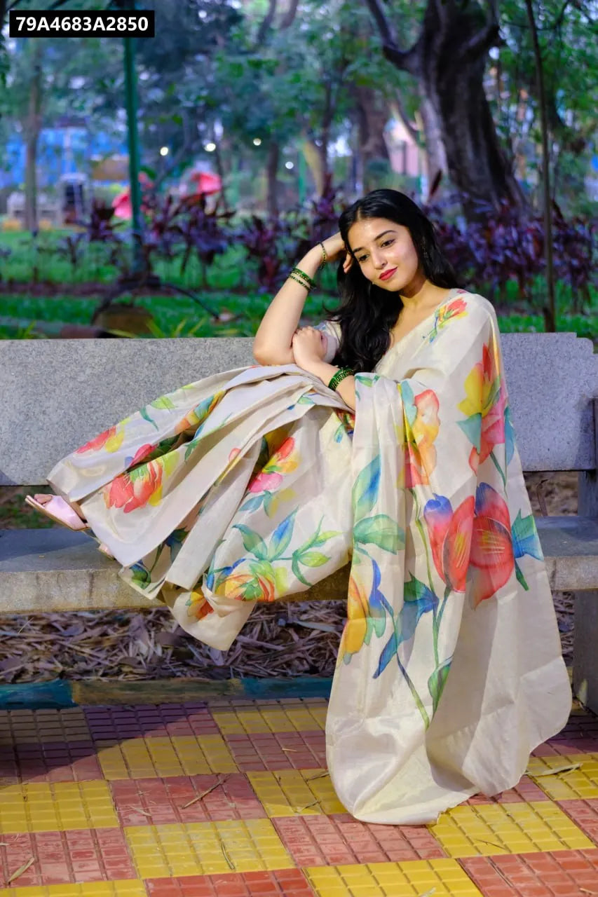 Model wearing TRENDBUY Handloom Tussar Silk Saree in cream with multi-color tulips digital print, sitting on a bench.