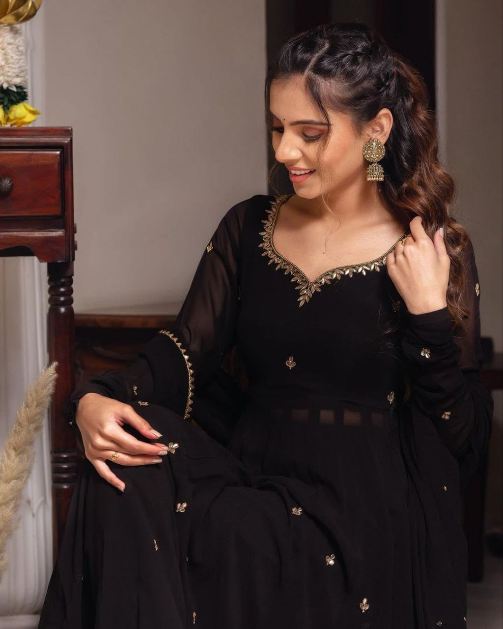 Woman in TRENDBUY Black Handwork Anarkali, smiling, highlighting the intricate gold work on the neckline and sleeve details.