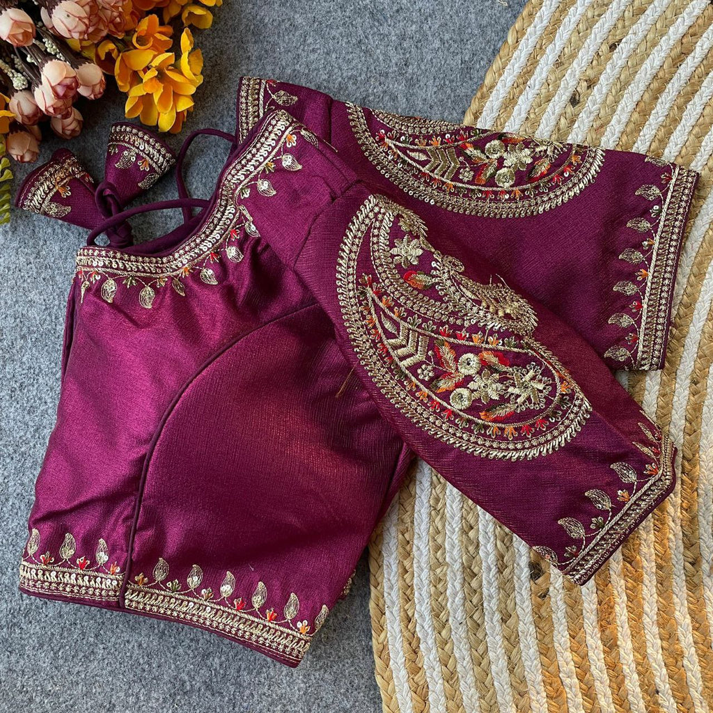 Magenta Milan Silk blouse with heavy gold and sequin embroidery on sleeves and neckline, showcasing a folded view.