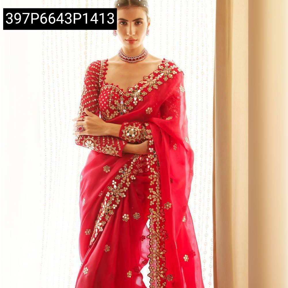 Model wearing red faux georgette saree with heavy mirror work and embroidery, front view.