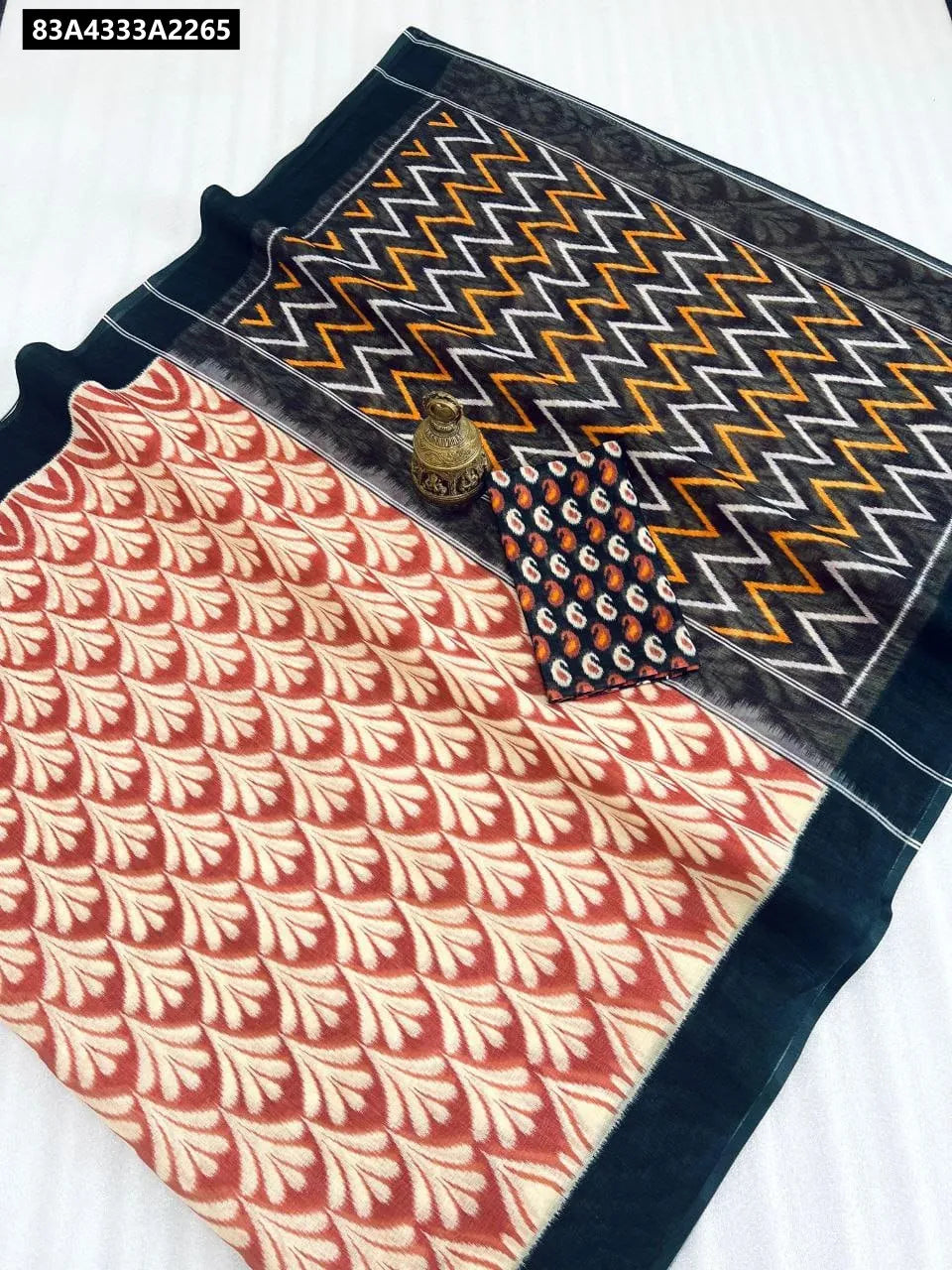Flat lay of Black Chevron Ikat digital print linen saree with matching blouse piece.