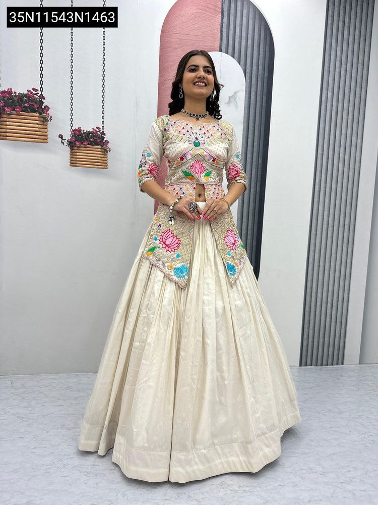 Full body front-facing shot of a smiling woman wearing an ivory simar cosmos embroidered lehenga set, clearly displaying the full outfit.