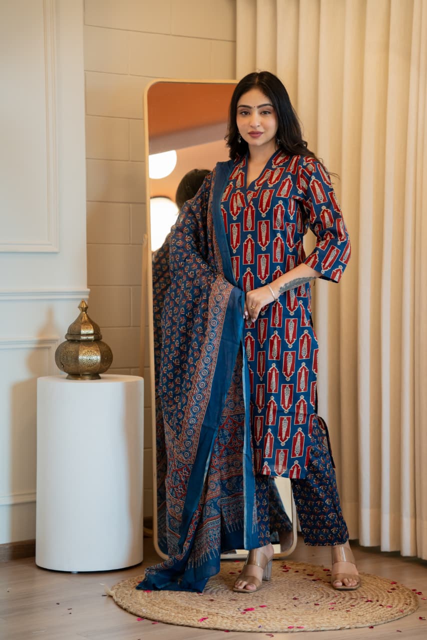 Woman posing in a stunning royal blue Jaipuri kurti set with red and cream block prints.