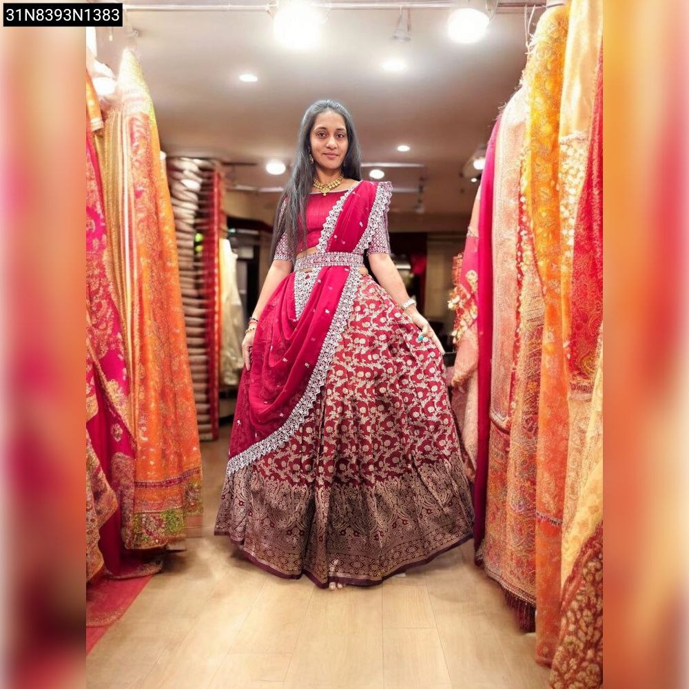 TRENDBUY Kanjiveram Silk Half Saree Lehenga in Maroon, featuring intricate zari weaving and embroidery, modeled by a woman in a fashion store.