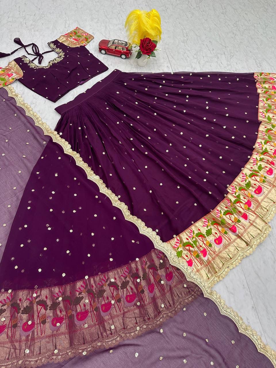 Close-up of intricate gold sequence embroidery on georgette fabric