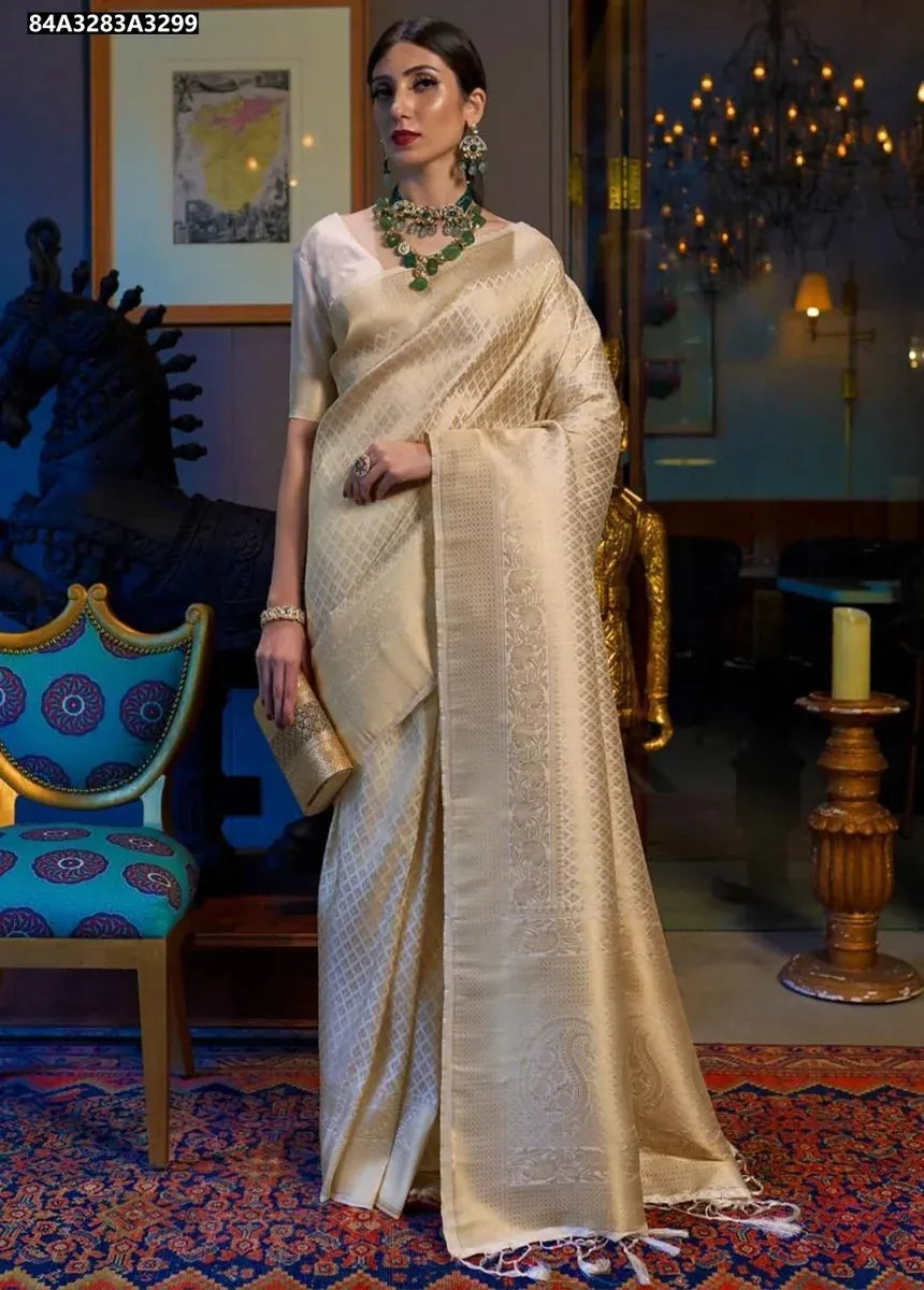 Elegant woman in champagne gold Lichi silk jacquard saree, standing front-facing, with traditional jewelry.