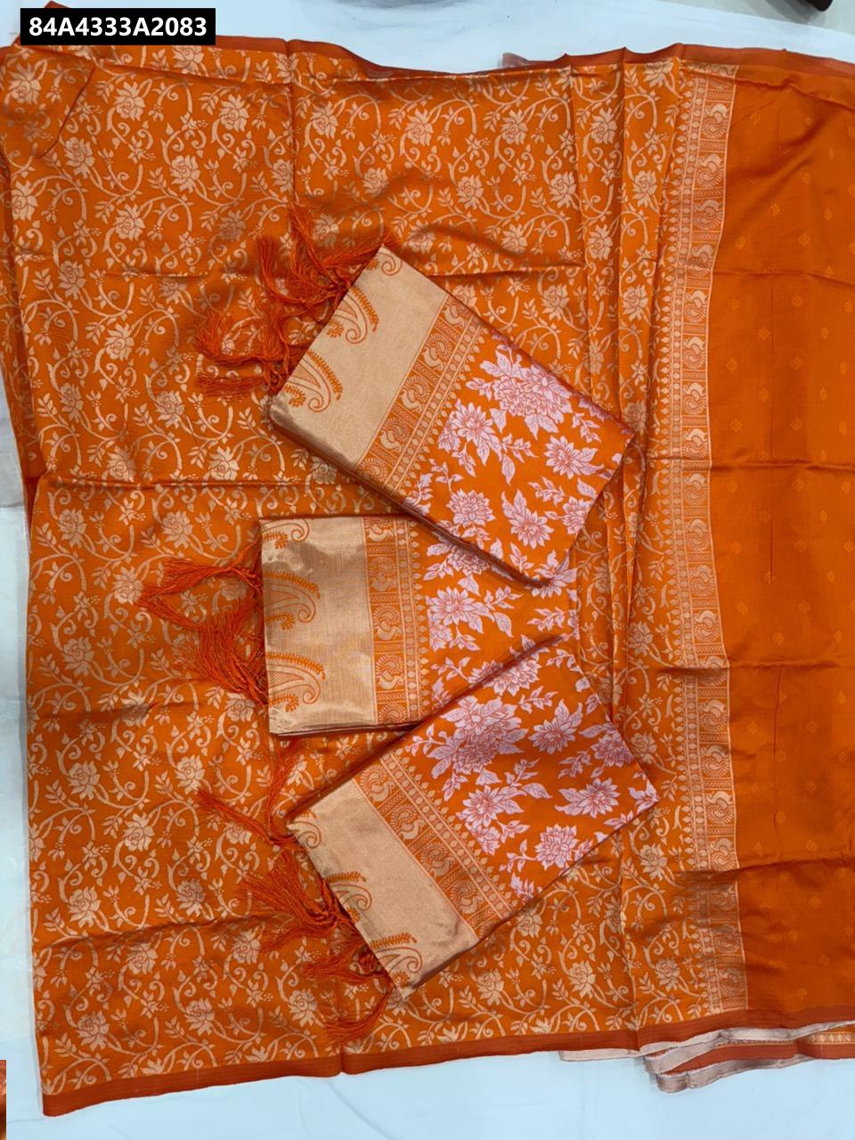 Close-up of intricate golden zari jacquard work on the rich pallu of the saree