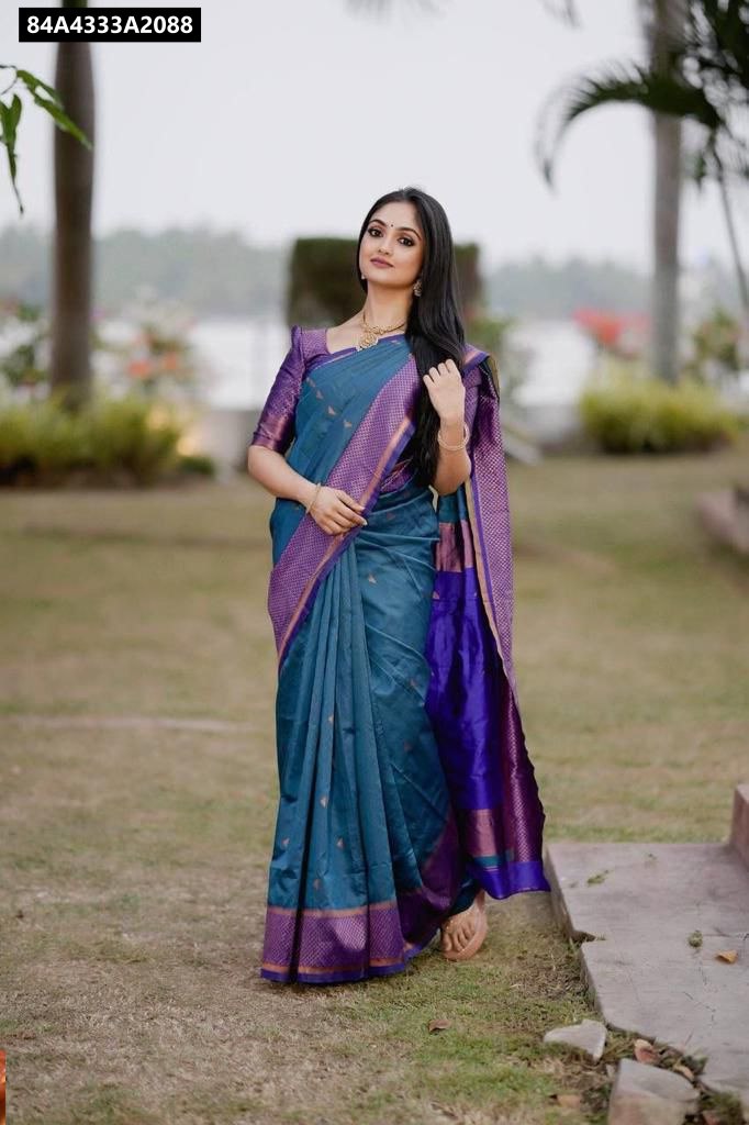 Front-facing shot of a model gracefully standing in a Teal and Purple Lichi Silk Saree outdoors.