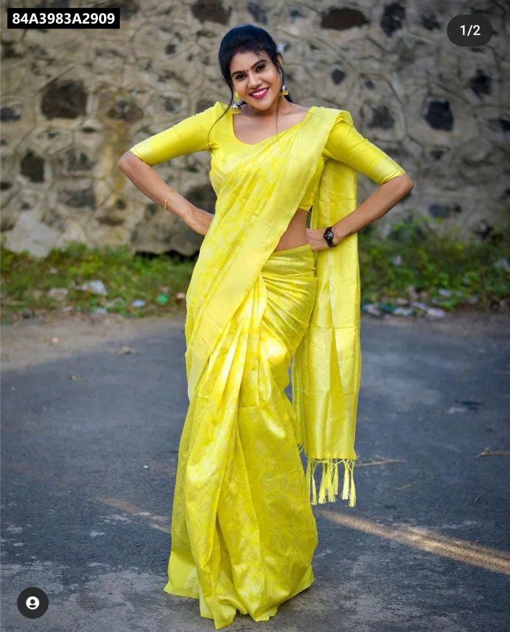 Smiling model in vibrant yellow Lichi Silk Jacquard Saree, full body shot on a street