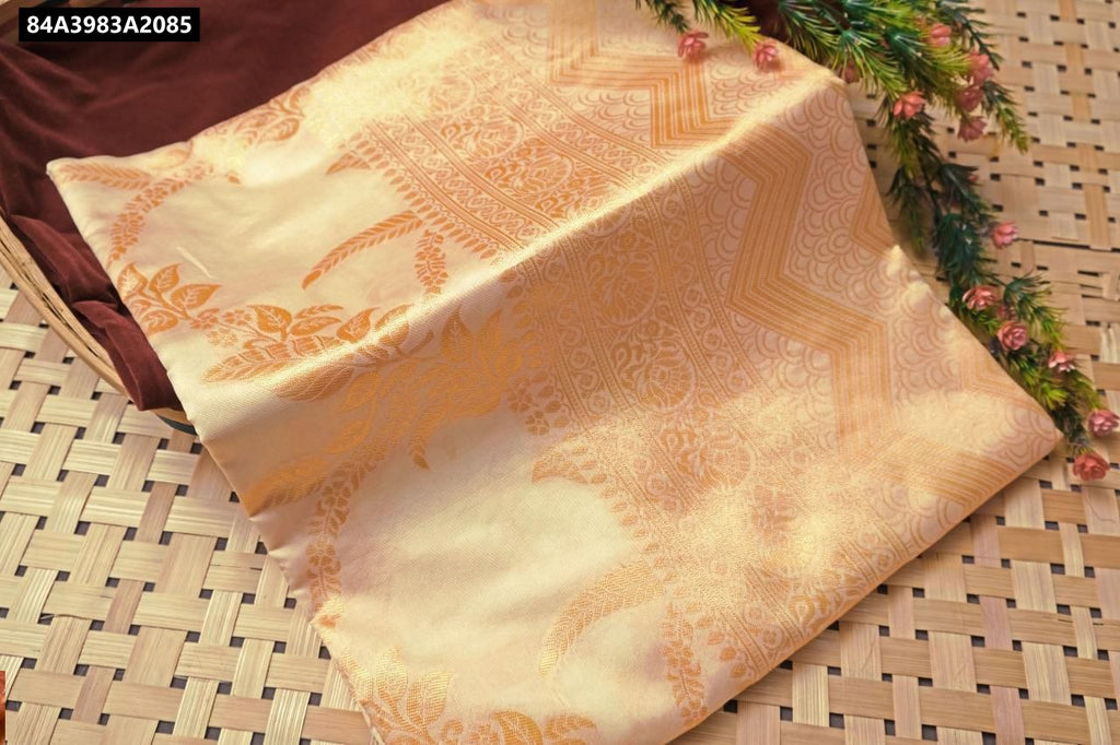 Close-up of the intricate gold zari jacquard weave pattern on the soft silk fabric.