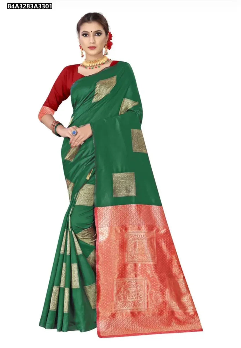 Confident front view of a model wearing a dark green Lichi silk saree with eye-catching golden jacquard design and a bold red blouse.