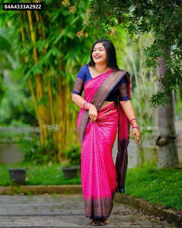 Woman smiling in hot pink Lichi Silk Jacquard Saree with navy blue blouse