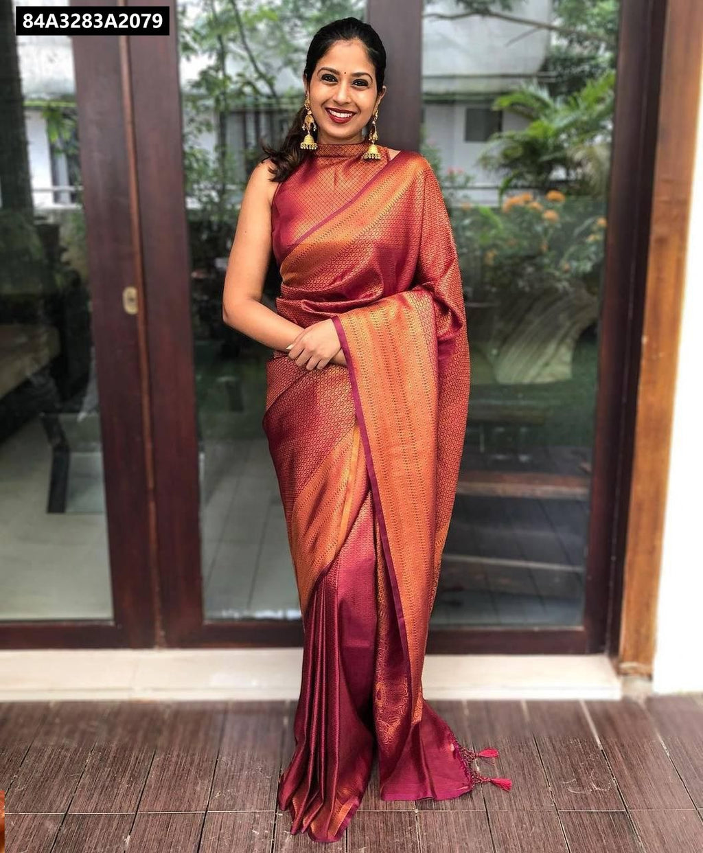 Woman in a Rich Maroon Lichi Silk Jacquard Saree, full body, front facing, smiling at camera.