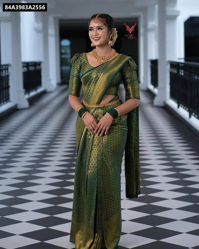 Full length front view of model in Teal Green Lichi Silk Saree with gold jacquard weave and traditional jewelry, standing on a checkered floor.