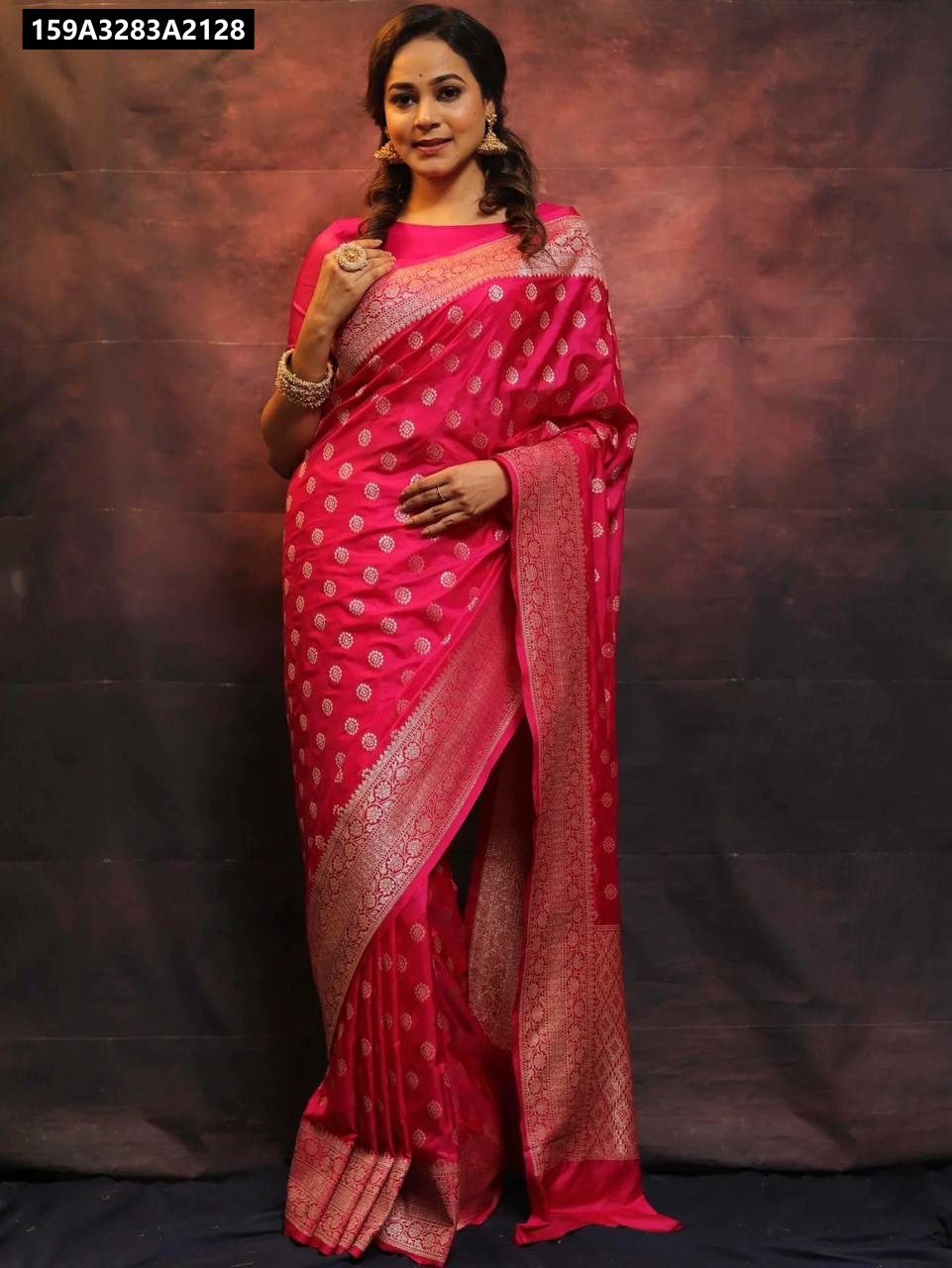 Model in a full body front-facing shot wearing a vibrant Fuchsia Pink Lichi Silk Saree with golden motifs