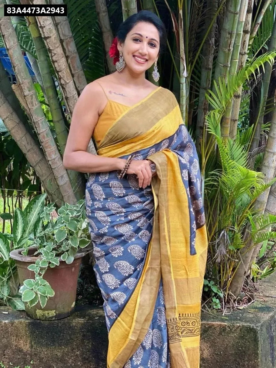 Woman in Indigo and Gold Linen Digital Print Saree with gold jari border, smiling front-on.