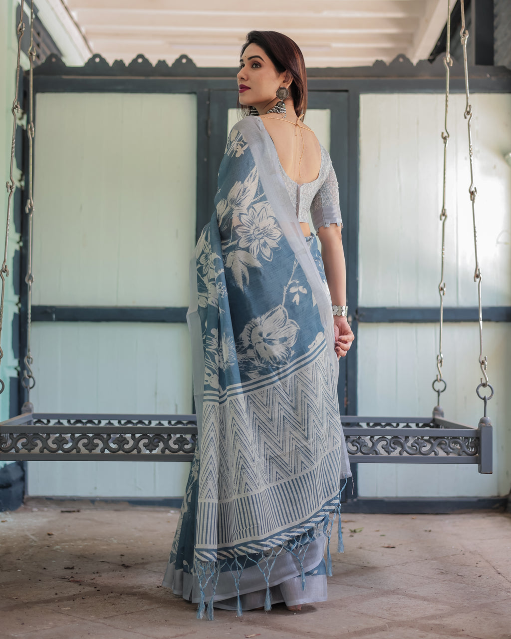 Close-up of the intricate white floral motifs printed on soft beige linen fabric