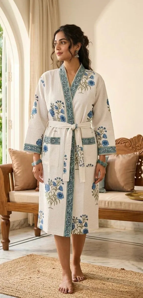 Woman wearing white waffle bathrobe with blue floral handblock print