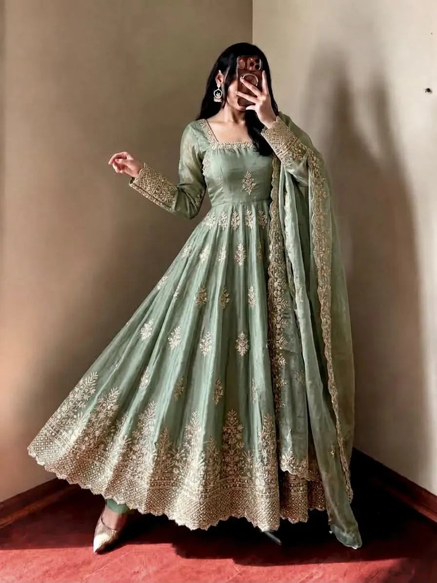 Full length view of woman in sage green designer silk gown with flair