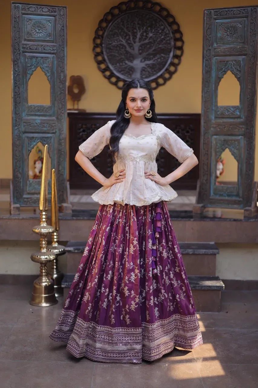 Model wearing wine-colored viscose jacquard lehenga with a cream embroidered blouse