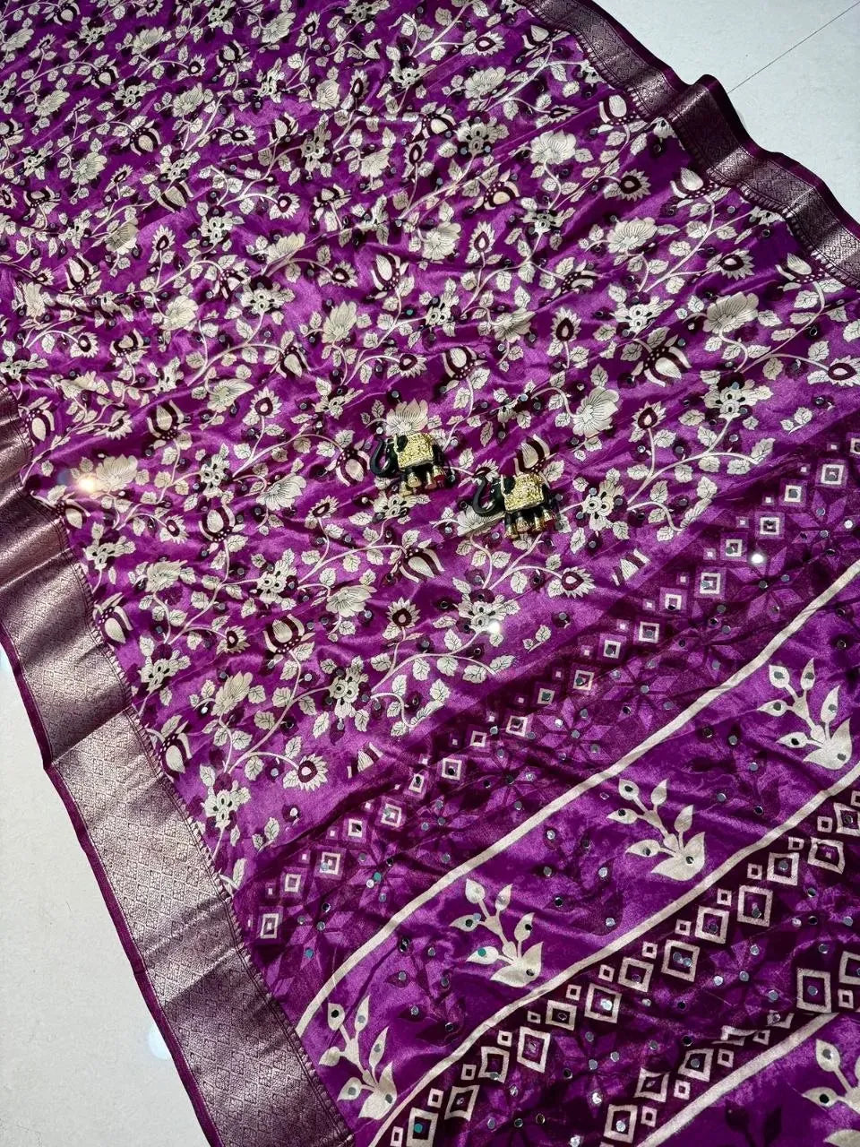 Purple dola silk saree draped showing full pattern and heavy mirror work