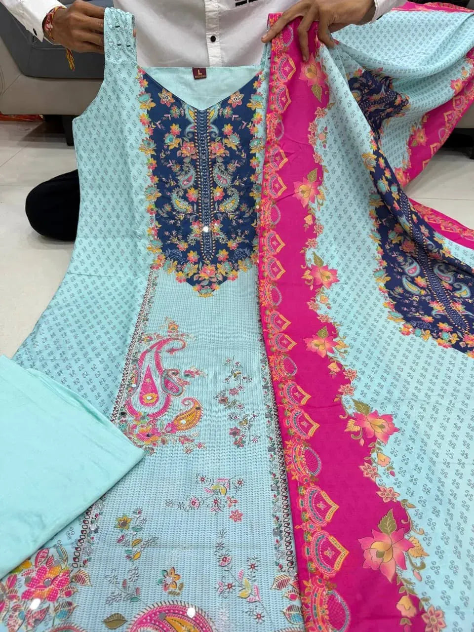 Full layout of light blue sleeveless kurta set with pink floral dupatta and pants