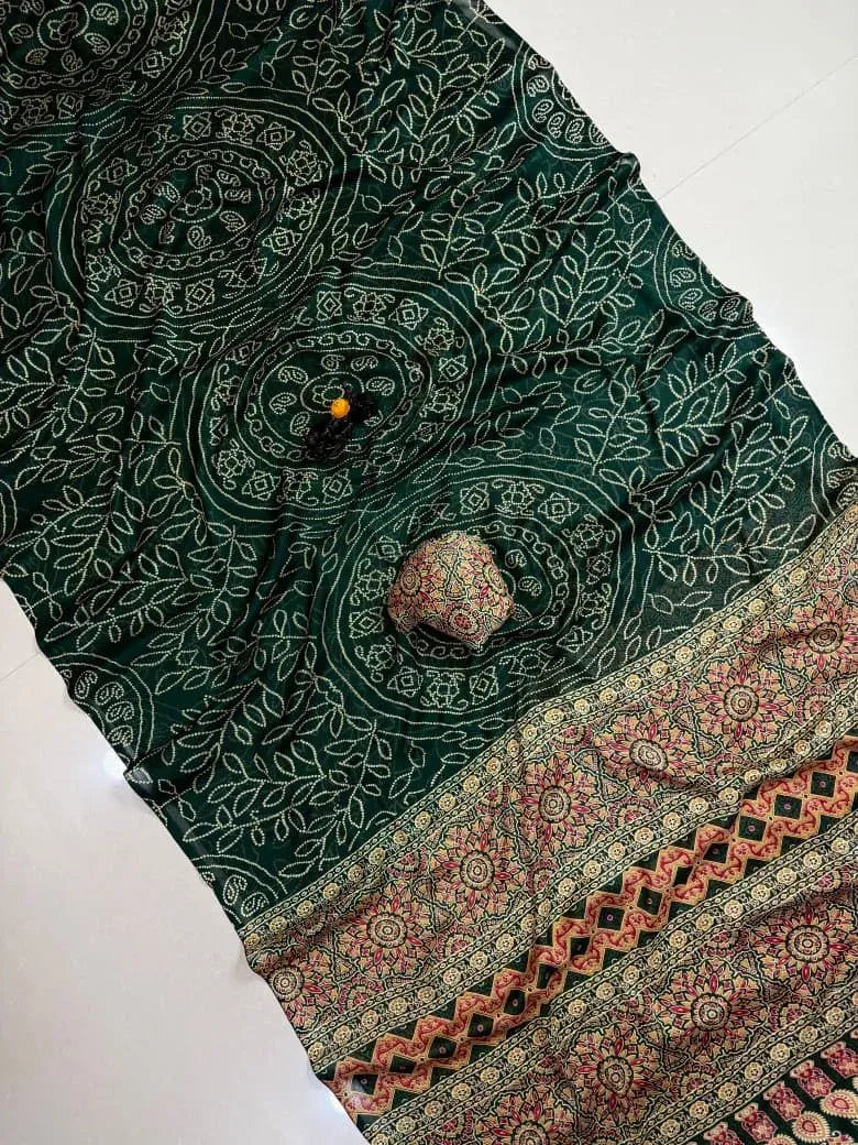 Dark green georgette saree flat lay with intricate print and contrasting border