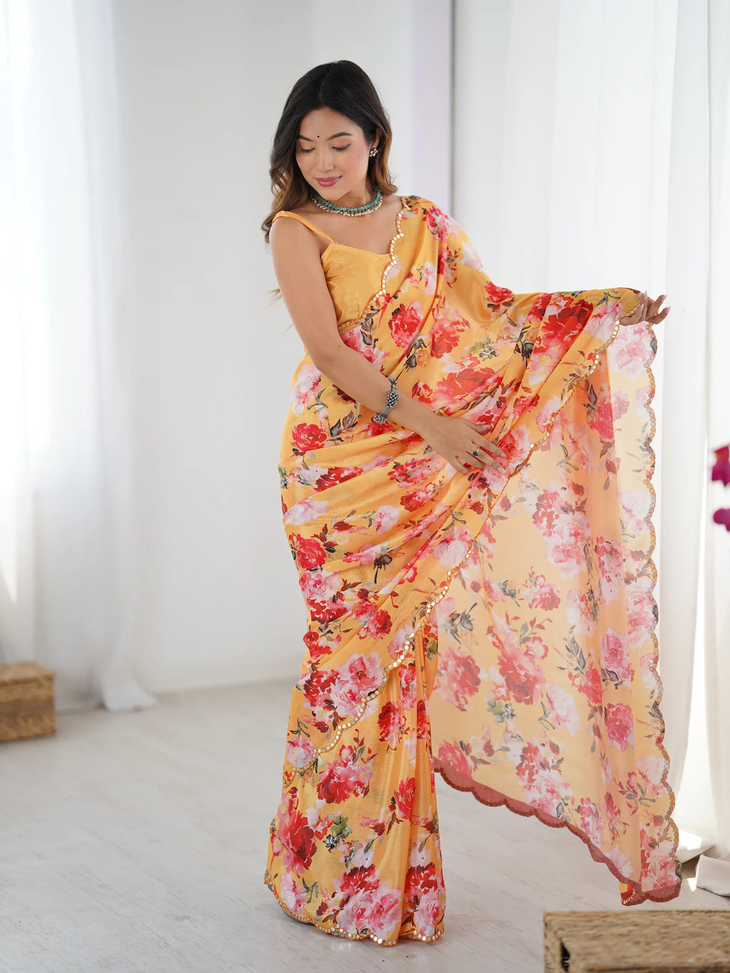 Front view of model displaying the drape and floral pattern of the chinnon saree