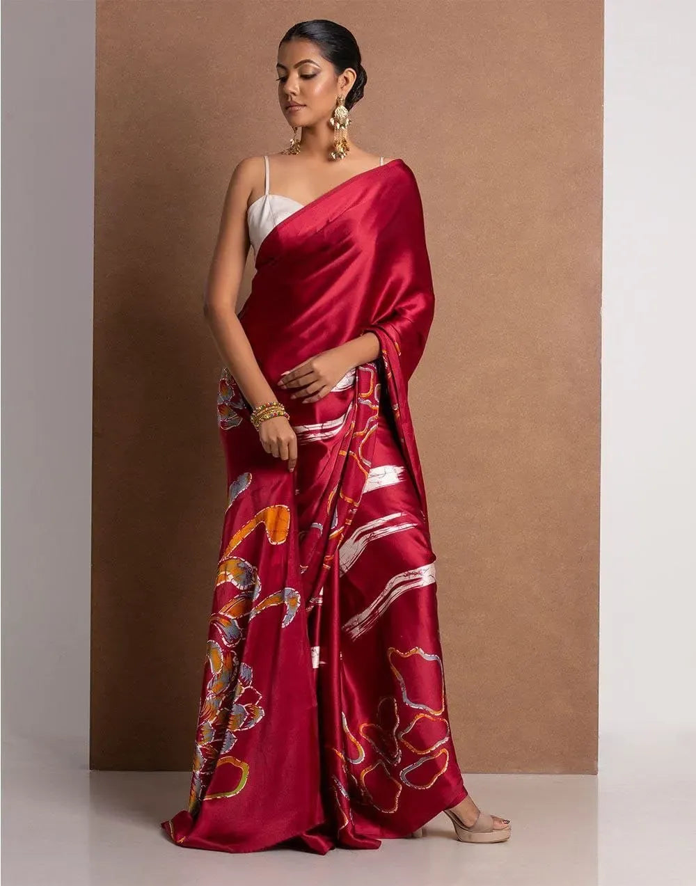 Model wearing rich maroon Japan satin saree with abstract digital print