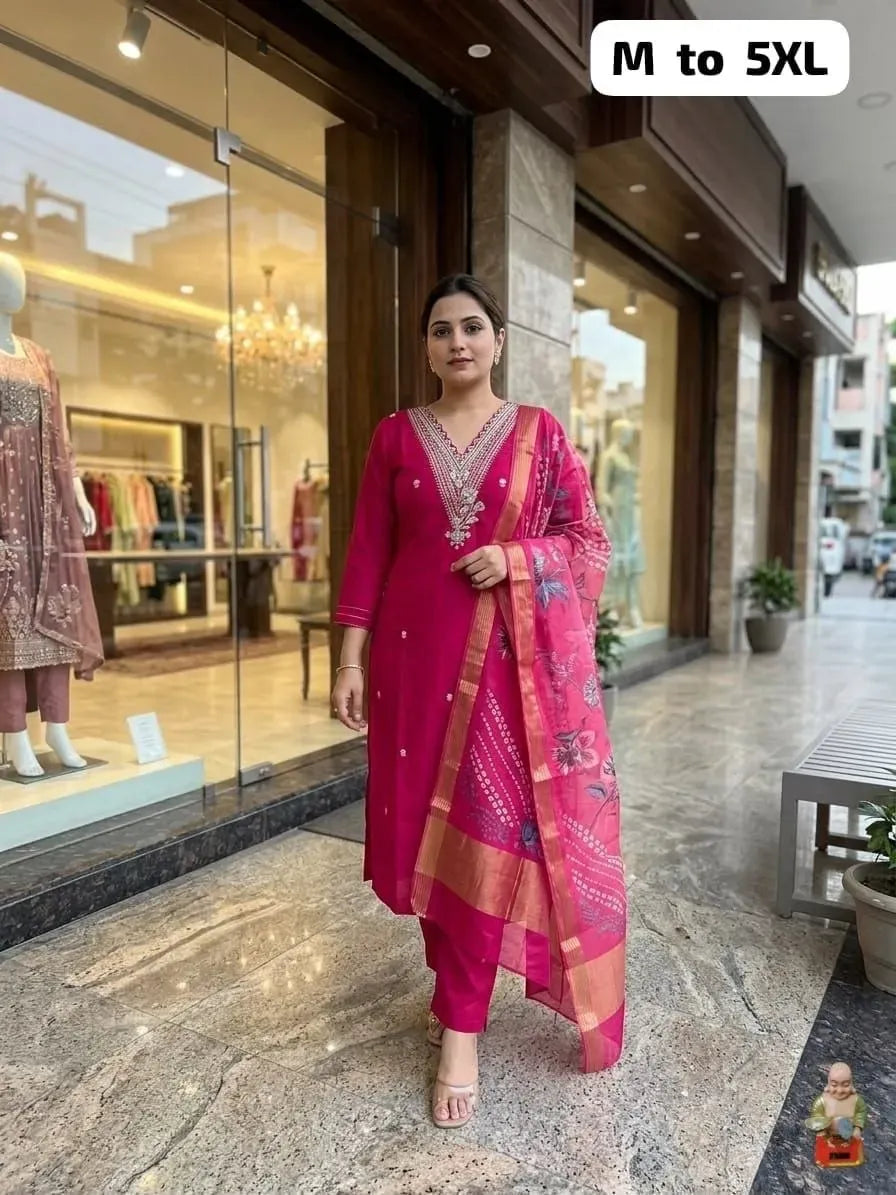 Model wearing dark pink muslin silk suit set with dupatta outside boutique