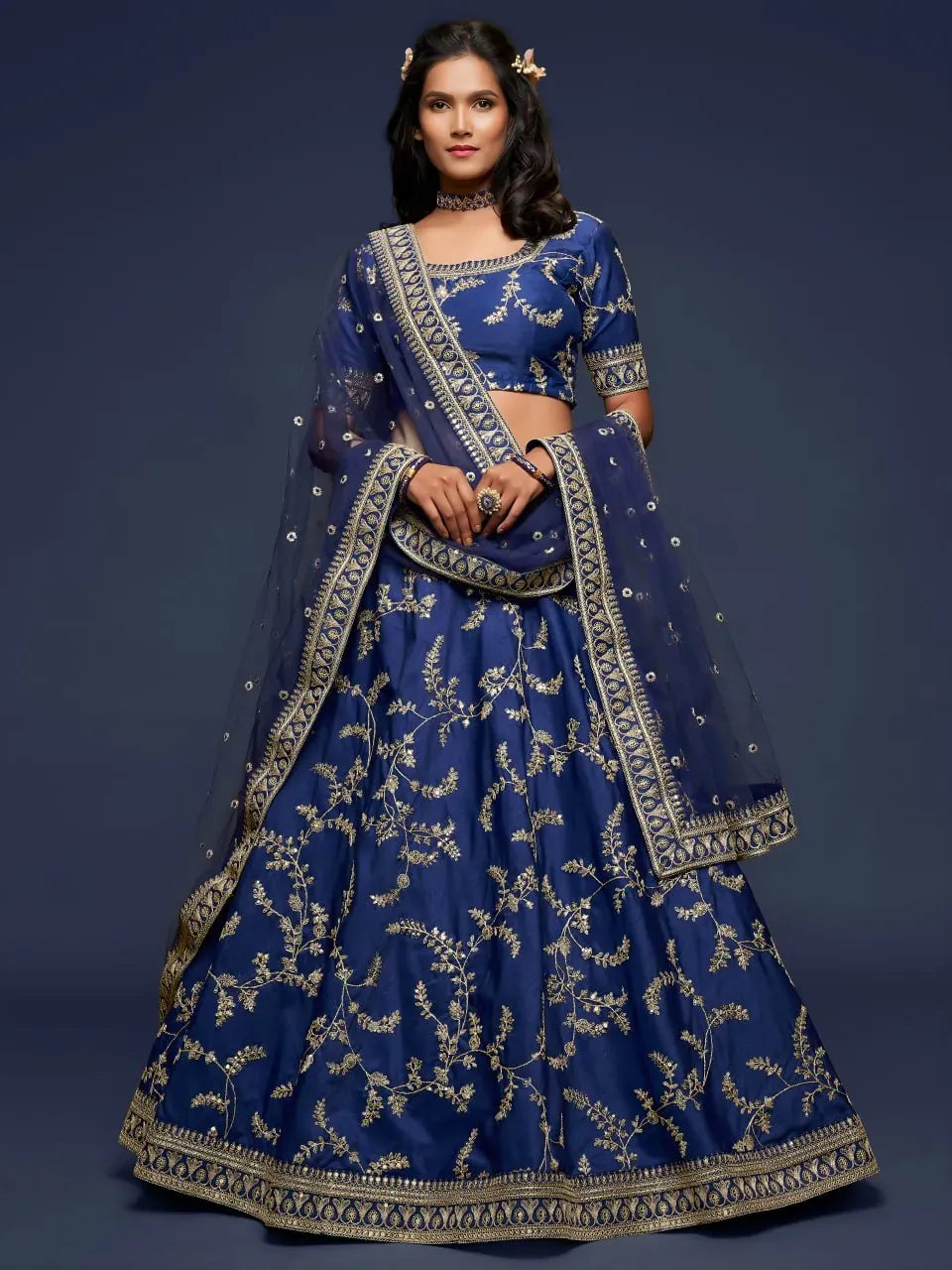 Full view of navy blue lehenga choli with gold floral vine embroidery