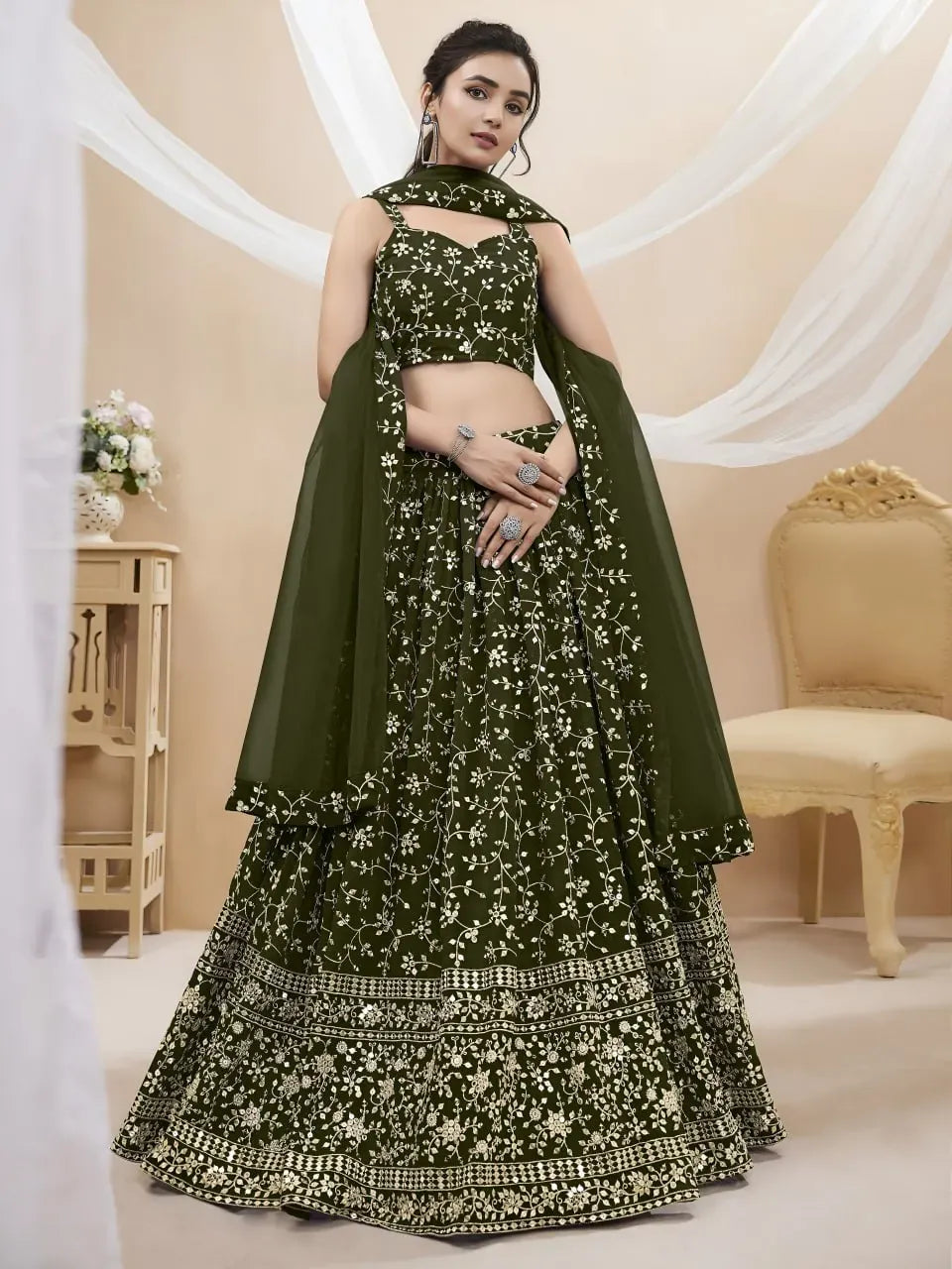 Full body front view of model wearing dark green embroidered lehenga set with sheer dupatta