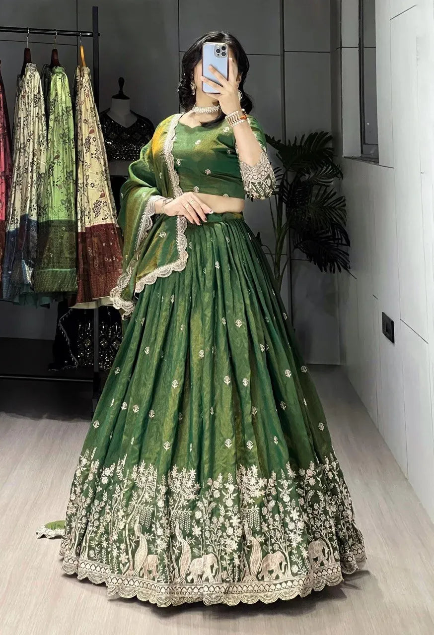 Model showcasing a rich olive green lehenga choli with intricate threadwork on the skirt border and dupatta