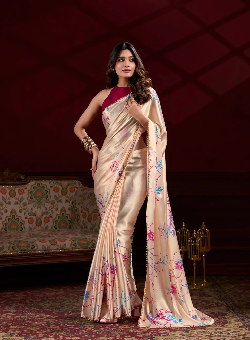 Model wearing beige satin silk saree with floral print and pearl border front view