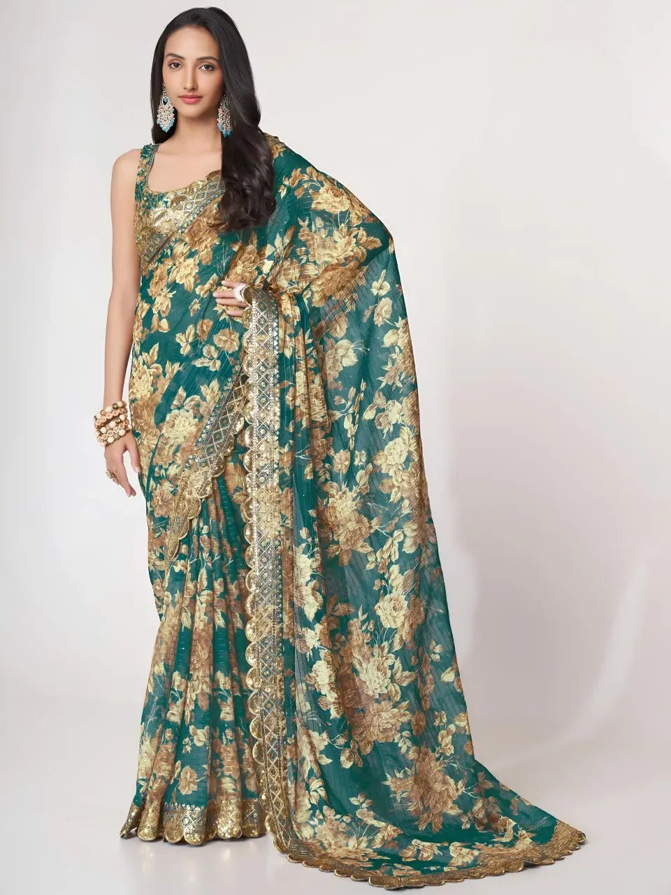 Model wearing teal floral organza saree with gold embroidery