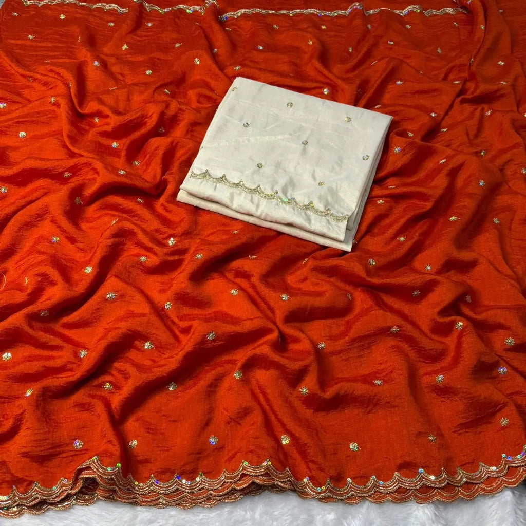 Draped rust orange Vichitra silk saree spread out with an off white tissue blouse piece in the center