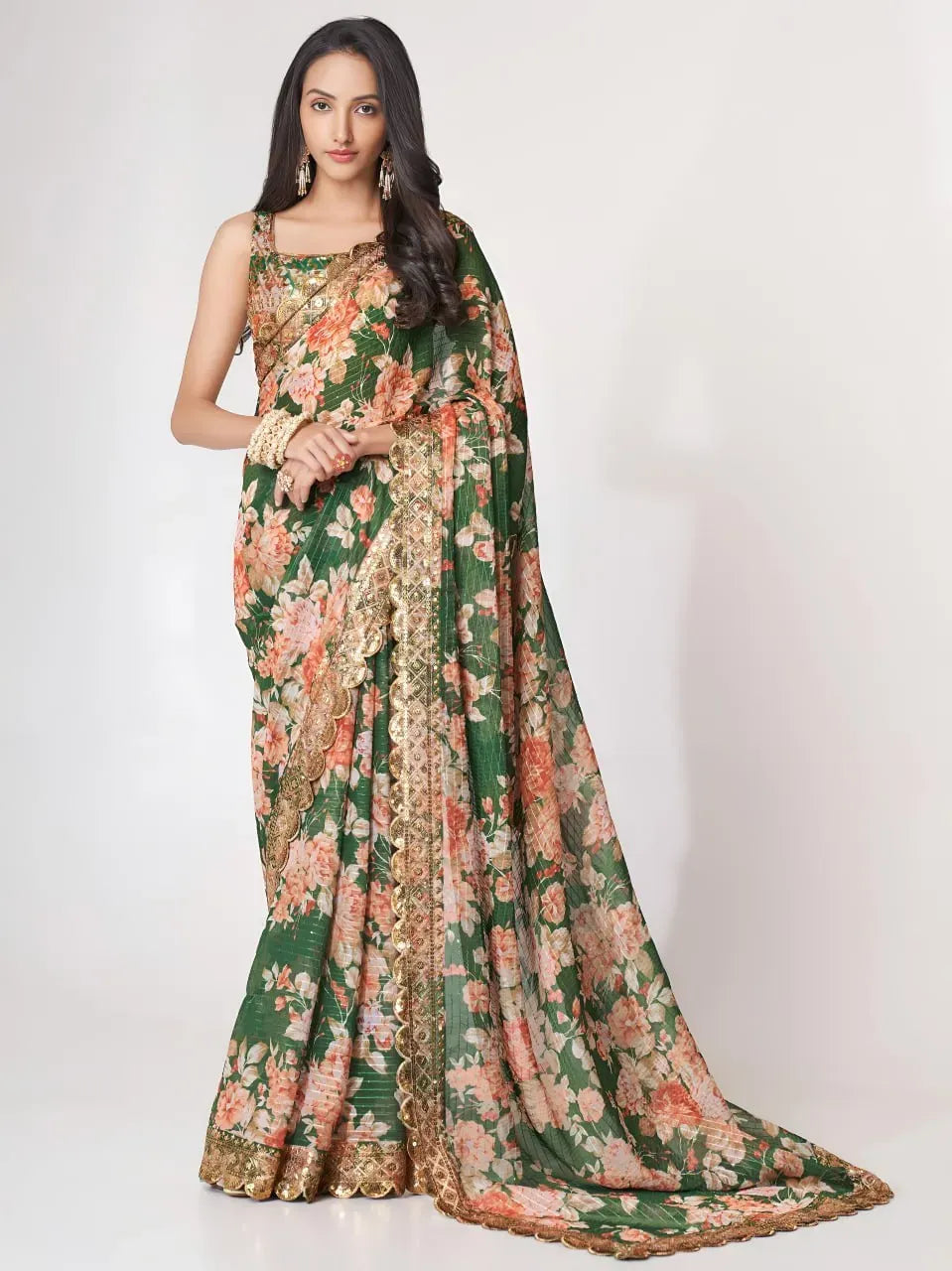 Model wearing emerald green floral print organza saree with gold border