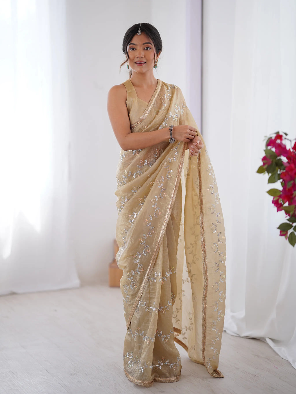 Model wearing gold crush saree with sequin embroidery