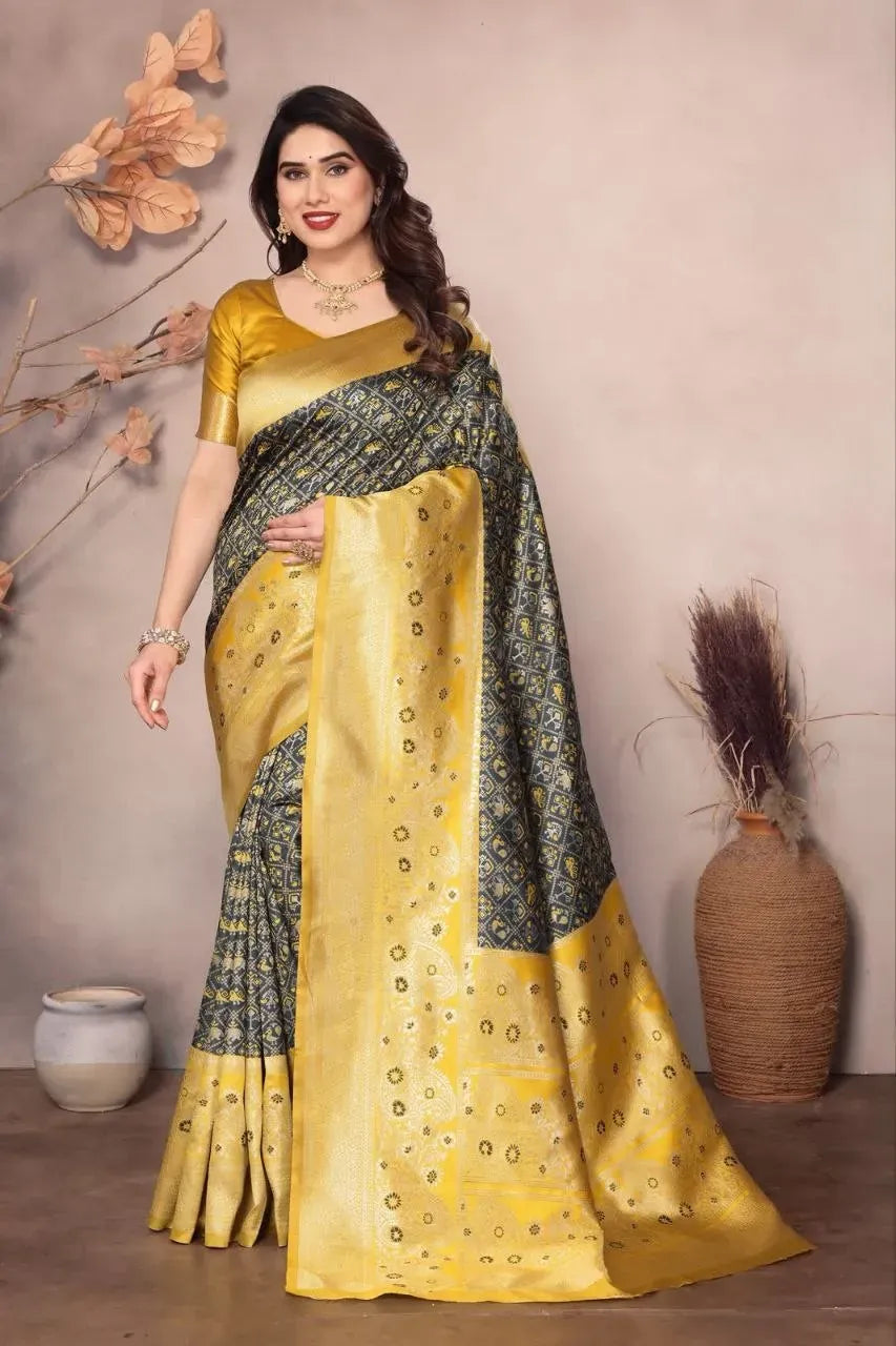 Model wearing grey and yellow lichi silk saree with golden belt