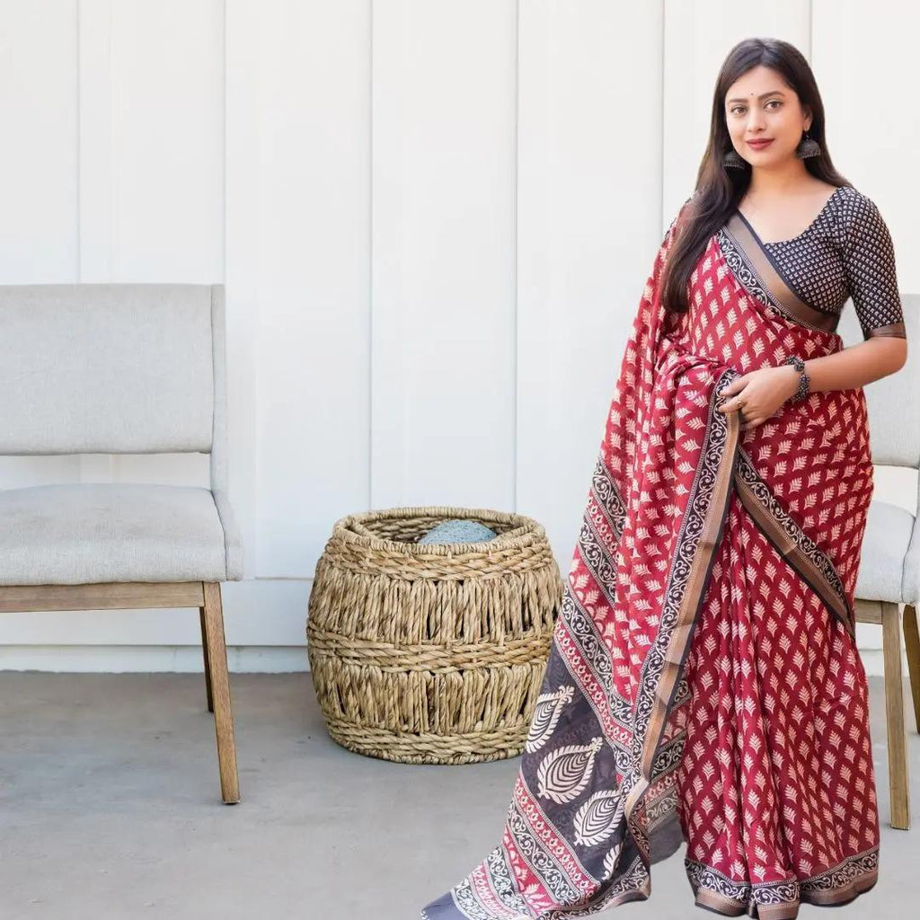 TRENDBUY Red Malmal Silk Saree with elegant prints and Zari border, styled with a black blouse